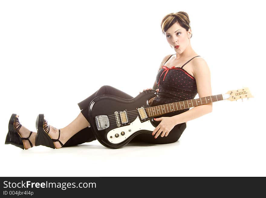 Woman in her thirties playing music on electric guitar. Woman in her thirties playing music on electric guitar