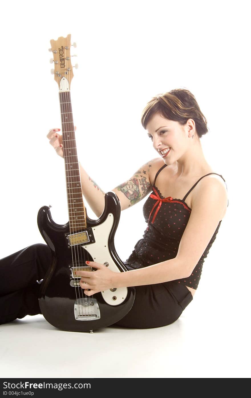 Woman in her thirties playing music on electric guitar. Woman in her thirties playing music on electric guitar