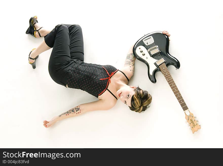 Woman in her thirties playing music on electric guitar. Woman in her thirties playing music on electric guitar