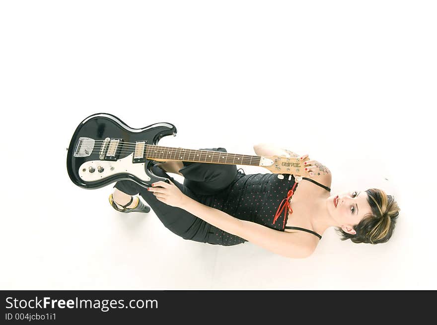 Woman in her thirties playing music on electric guitar. Woman in her thirties playing music on electric guitar