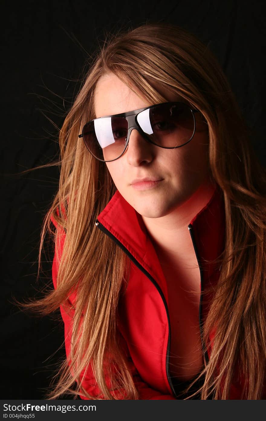 Girl wearing red jacket showing cleavage leaning over a chair. Girl wearing red jacket showing cleavage leaning over a chair