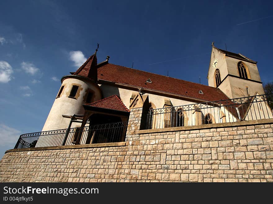 Church in the street of a alsacian villlage in the summer. Church in the street of a alsacian villlage in the summer