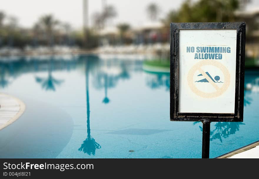 No Swimmin Allowed over swimming pool background. No Swimmin Allowed over swimming pool background.