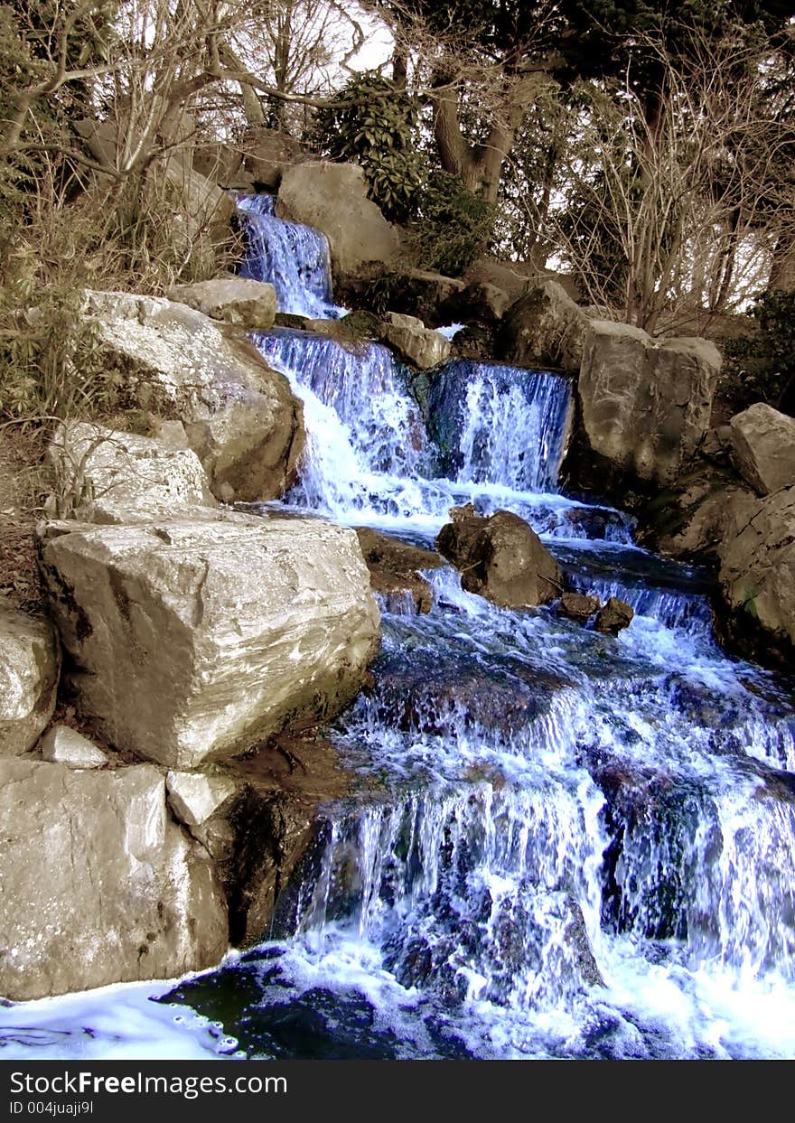 Big grandiose waterfall with plants in the nature