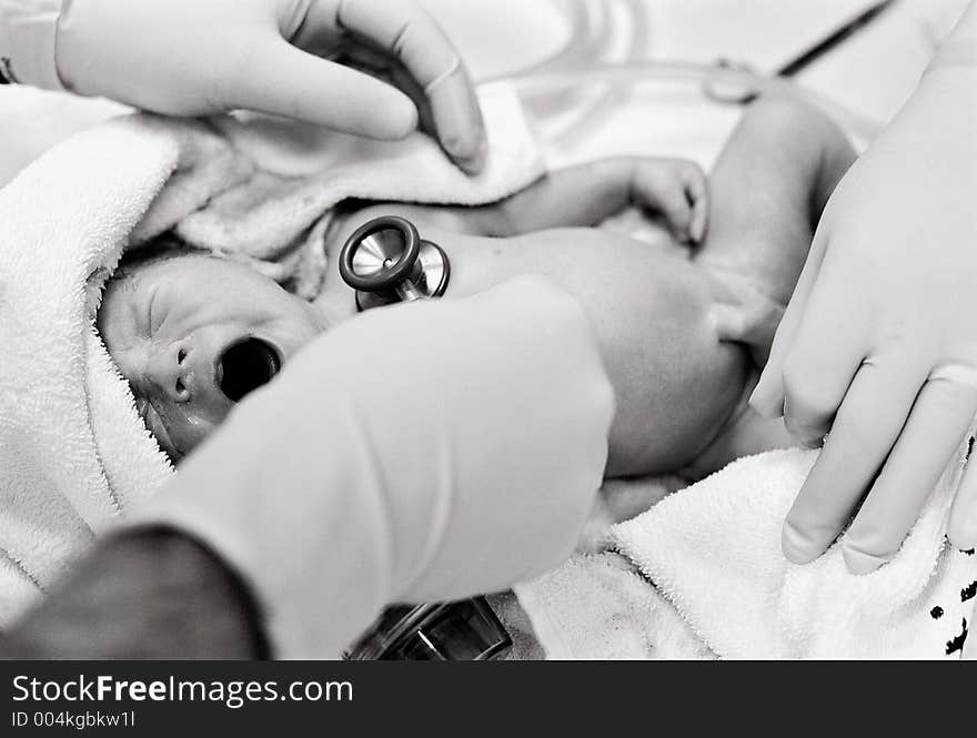 Newborn Baby being checked minutes after birth by Paediatrician. Film grain visible.