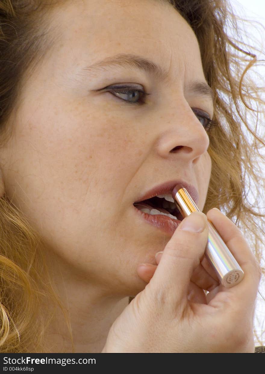 Blonde woman putting on her morning make up