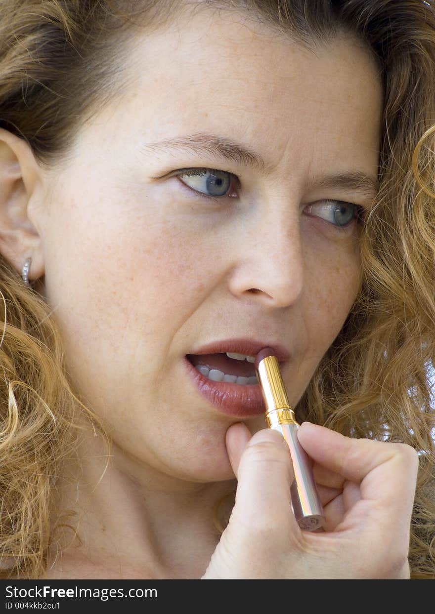 Blonde woman putting on her morning make up