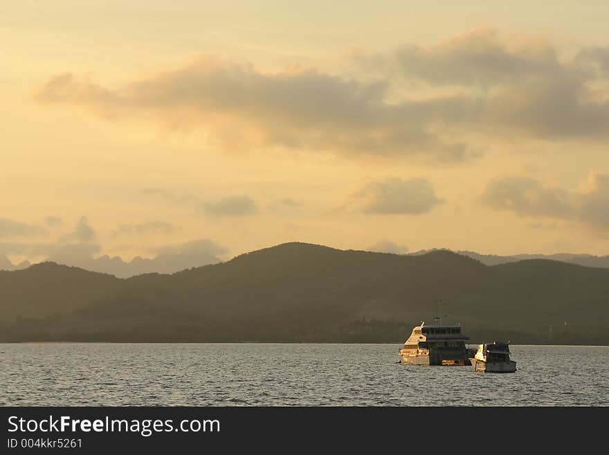 Boats crossing the calm seas during sunset near Langkawi Island, Malaysia. Boats crossing the calm seas during sunset near Langkawi Island, Malaysia