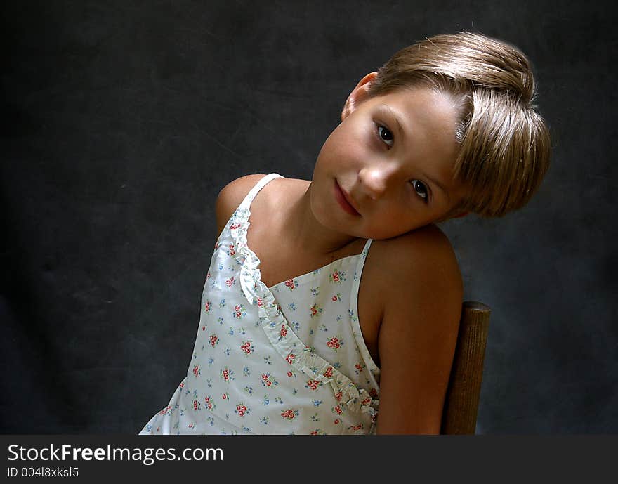 The girl who has inclined a head on a dark background. The girl who has inclined a head on a dark background.