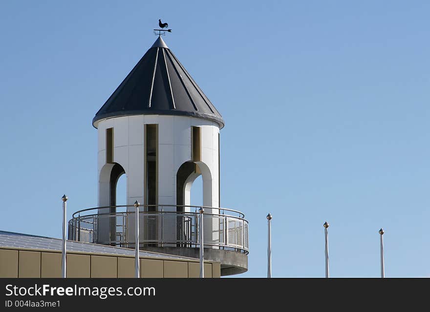 White tower with flapoles rising up. White tower with flapoles rising up