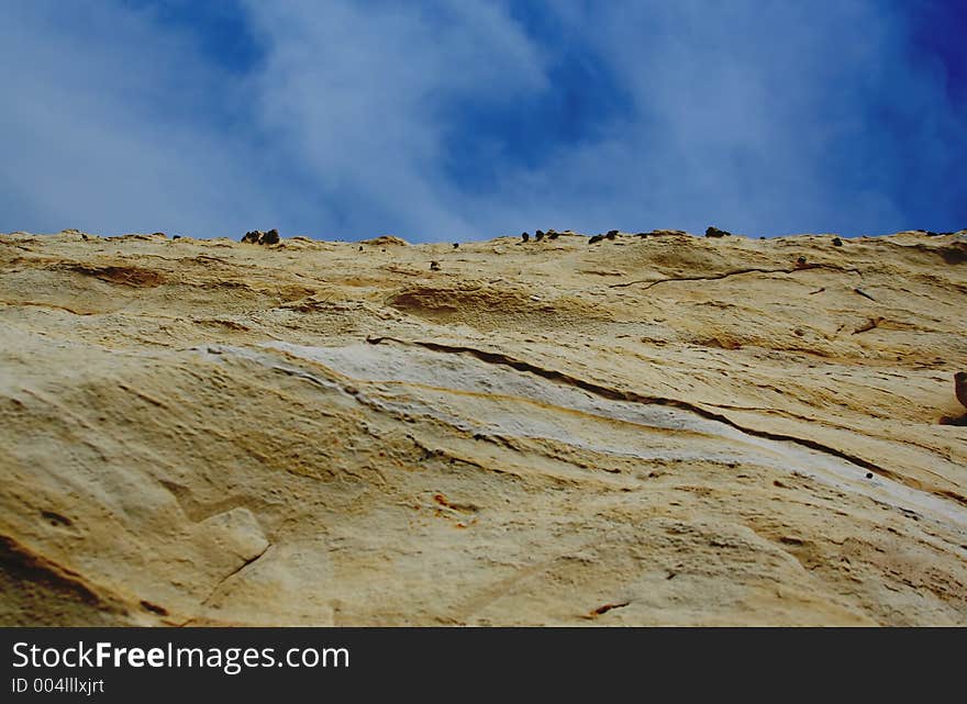 Rock with blue sky and clouds