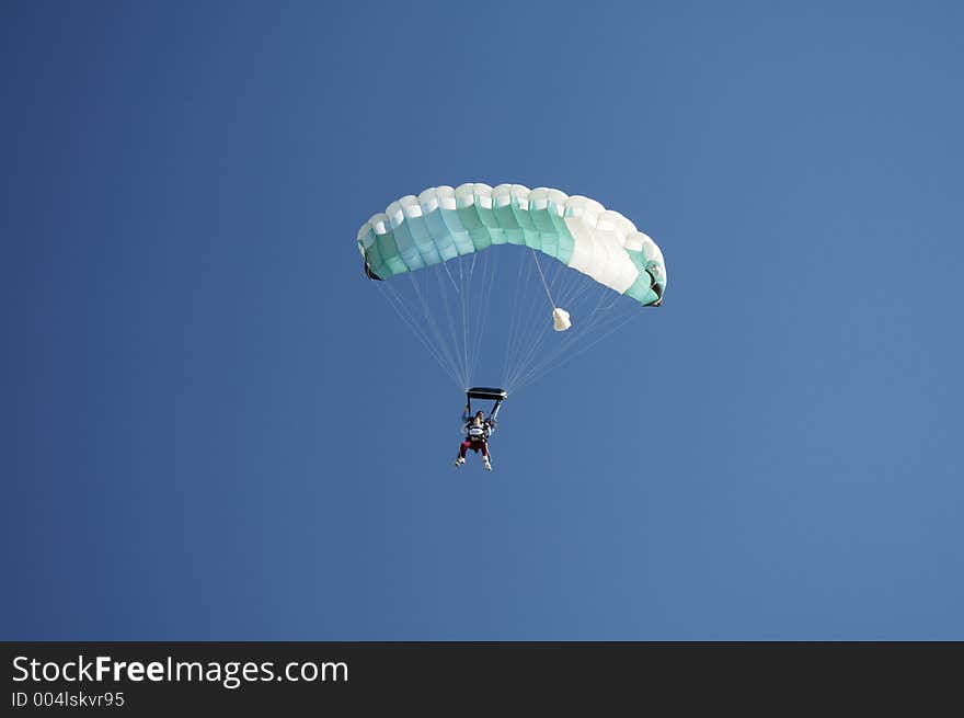 Skydivers perpare to land during a tandem jump. Skydivers perpare to land during a tandem jump.