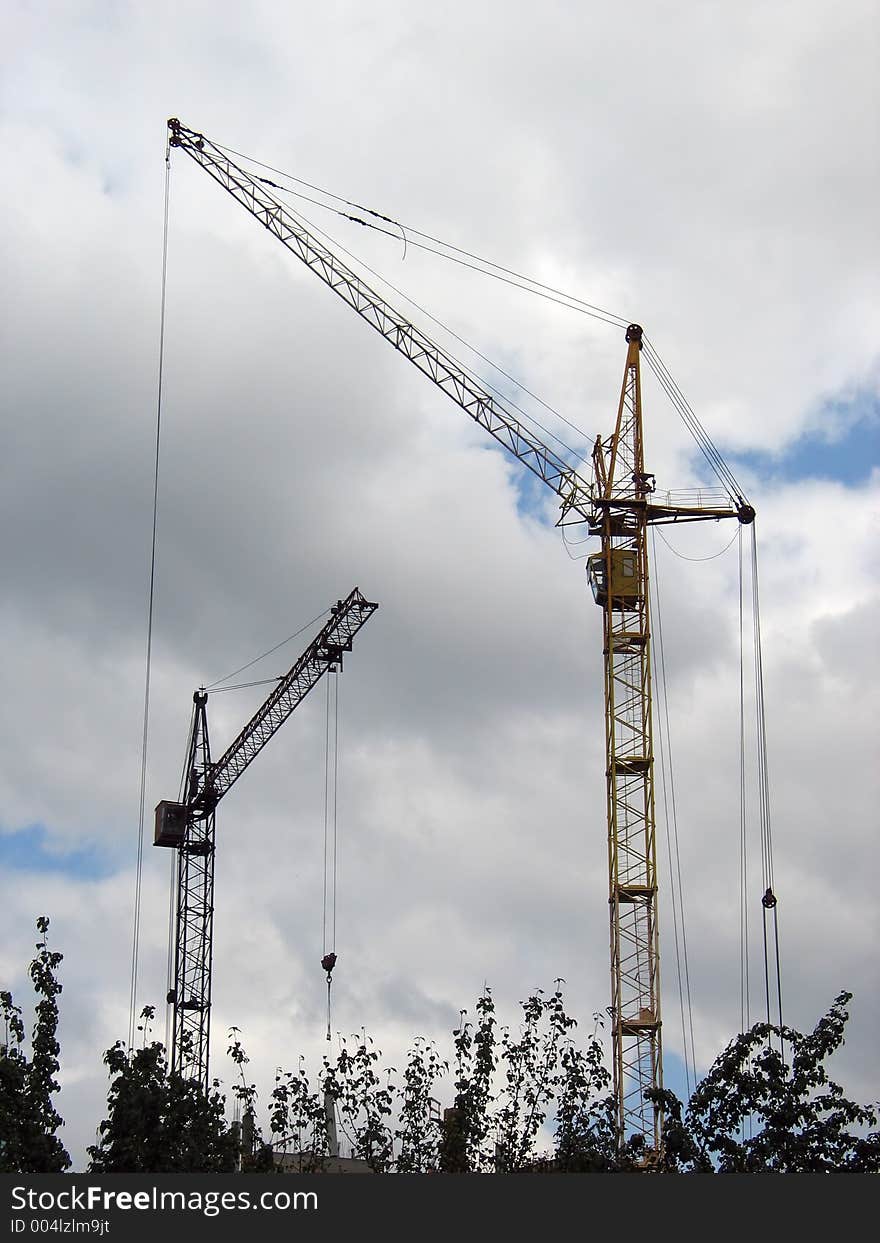 Cranes over cloudy sky