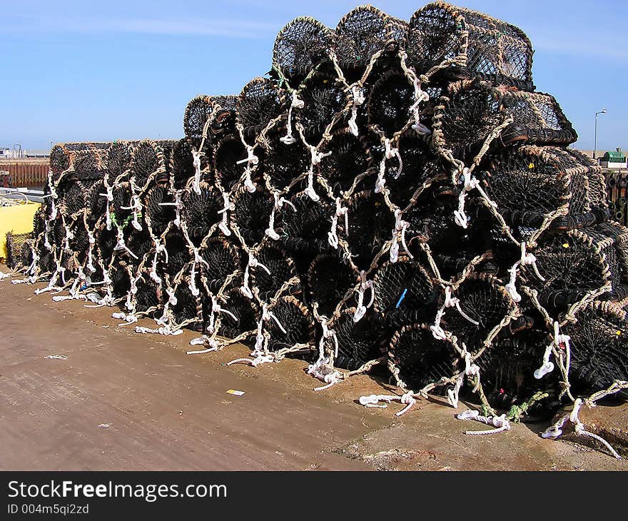 A load of creels for either lobsters or crabs waiting quayside to be taken to sea and laid out in their chain. Replacement ropes can be seen. A load of creels for either lobsters or crabs waiting quayside to be taken to sea and laid out in their chain. Replacement ropes can be seen.