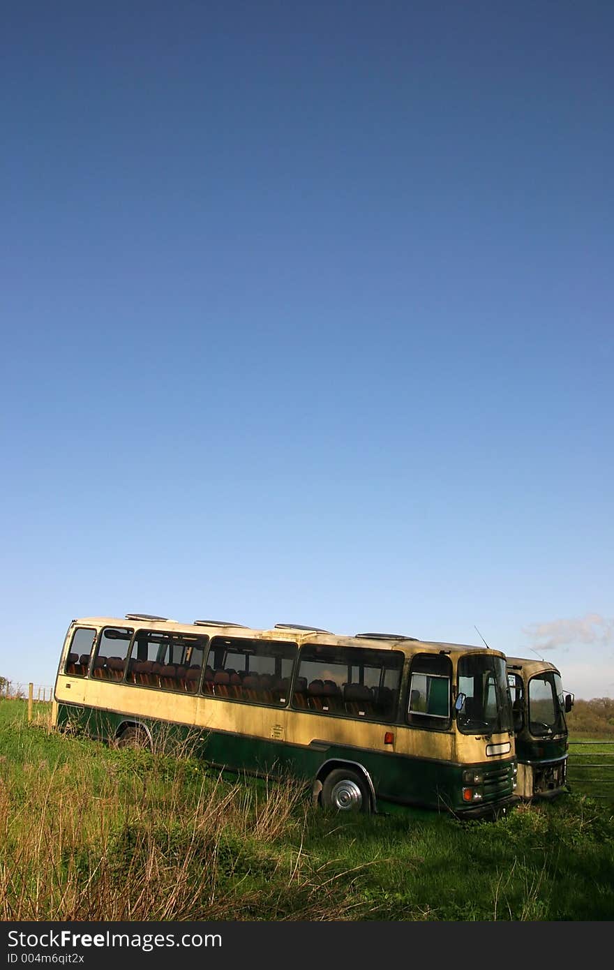 Two old coaches left to rot on grassy bank in UK. Two old coaches left to rot on grassy bank in UK