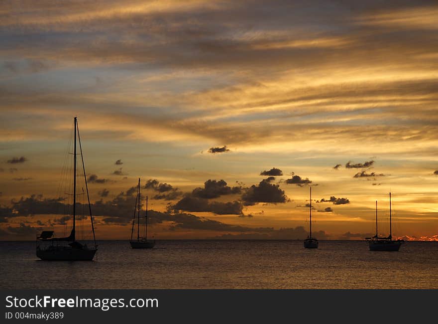 Colourful caribbean sunset with sailboats. Colourful caribbean sunset with sailboats