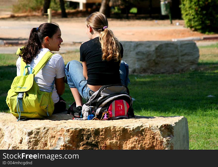 Kids sitting on a rock. Kids sitting on a rock