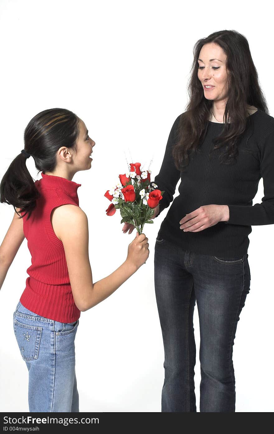 Daughter offering flowers to her mother. Daughter offering flowers to her mother