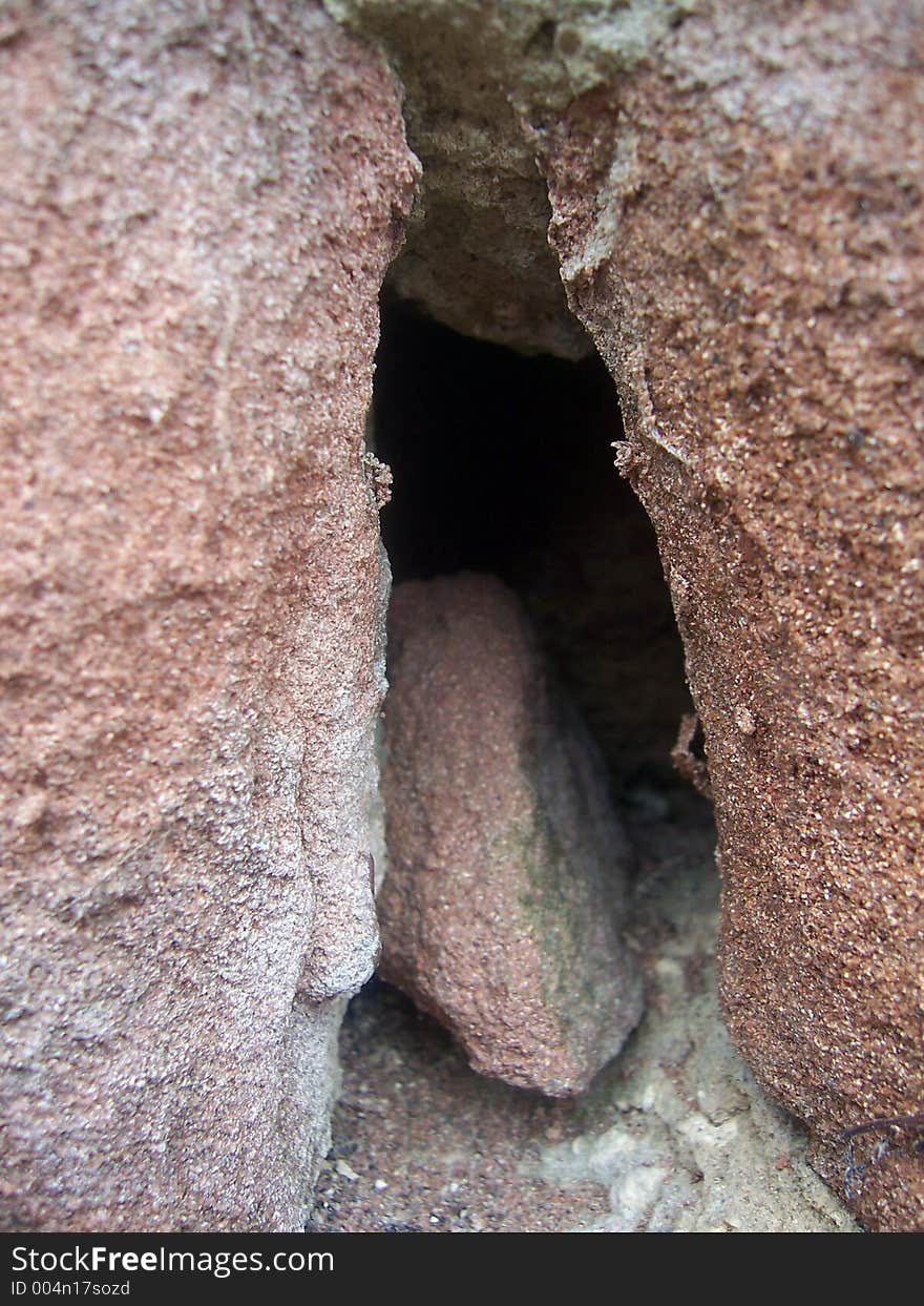 A piece of sandstone in a sandstone crevice. A piece of sandstone in a sandstone crevice