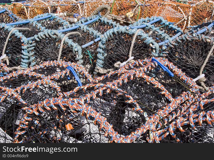 Multi-colored lobster traps piled high on the shore. Interesting textures and colors. Multi-colored lobster traps piled high on the shore. Interesting textures and colors.