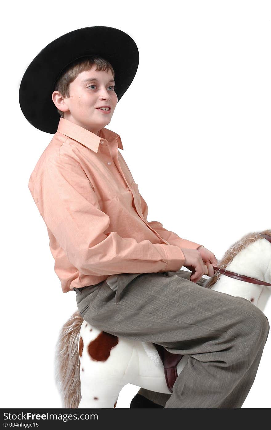 Teen boy makes fun of toy horse. When he grows up, he wants to be a cowboy. Teen boy makes fun of toy horse. When he grows up, he wants to be a cowboy.