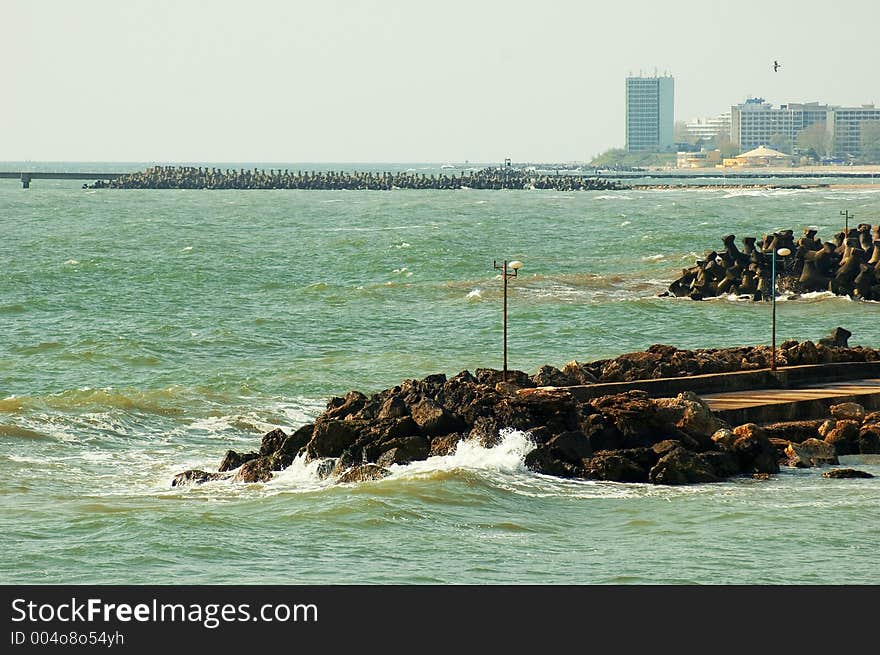 Black Sea with extended jetties and resort on shoreline at Olimp resort in Romania. Black Sea with extended jetties and resort on shoreline at Olimp resort in Romania.