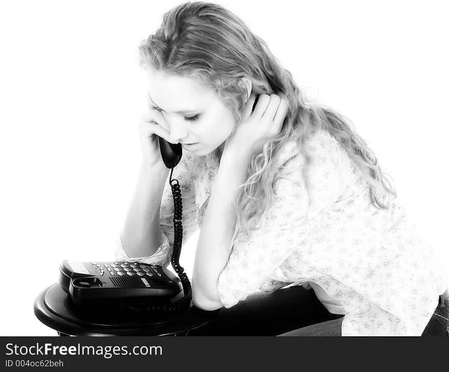 Pretty female teen talking on a telephone. Black and white. Pretty female teen talking on a telephone. Black and white.