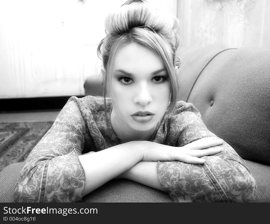 Beautiful Hispanic woman laying on couch in grungy apartment. Black and white. Beautiful Hispanic woman laying on couch in grungy apartment. Black and white.