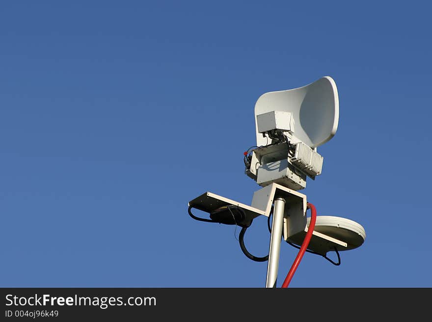 The microwave dish antenna on top of the remote news van mast. The microwave dish antenna on top of the remote news van mast.