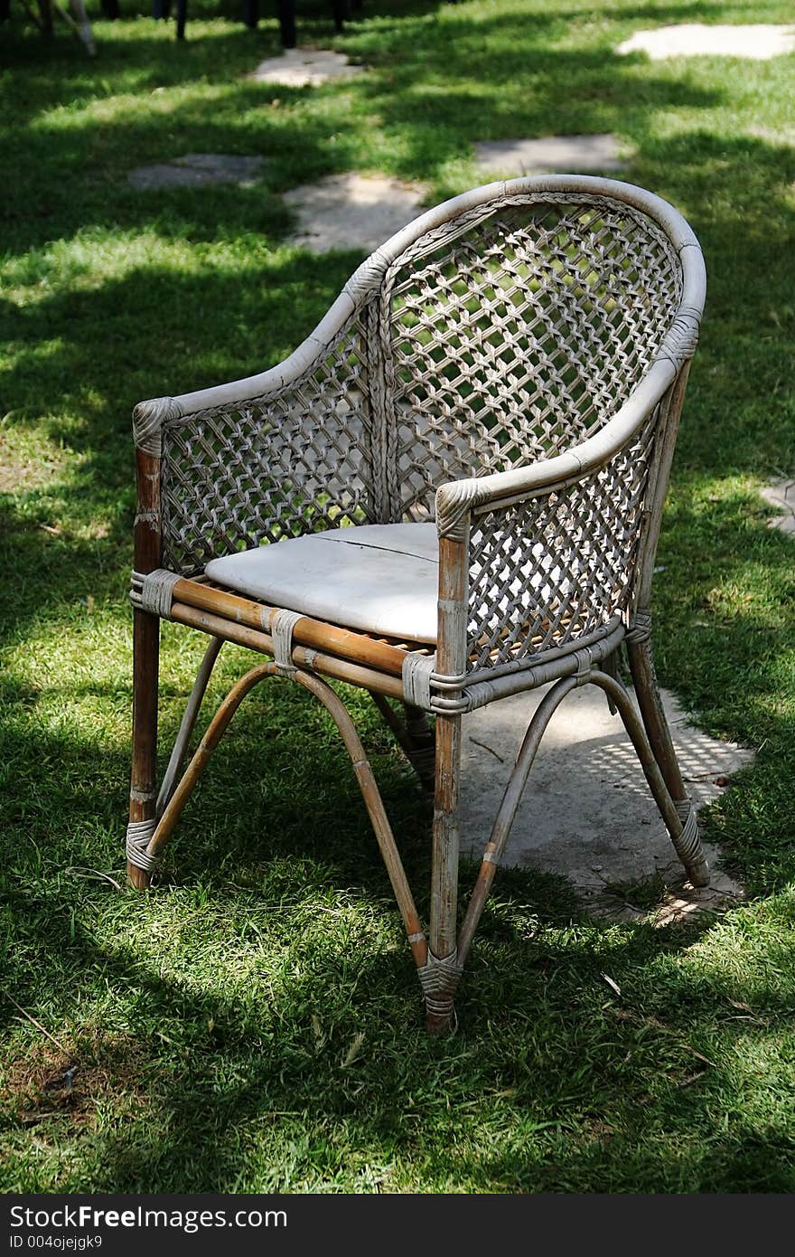 Old White garden chair in a grass floor