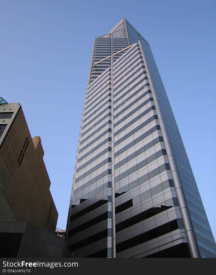 Highrise building with glass walls, upwards view. Highrise building with glass walls, upwards view