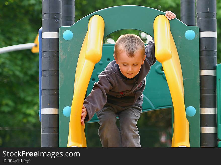 Child preparing for slide in the park. Child preparing for slide in the park