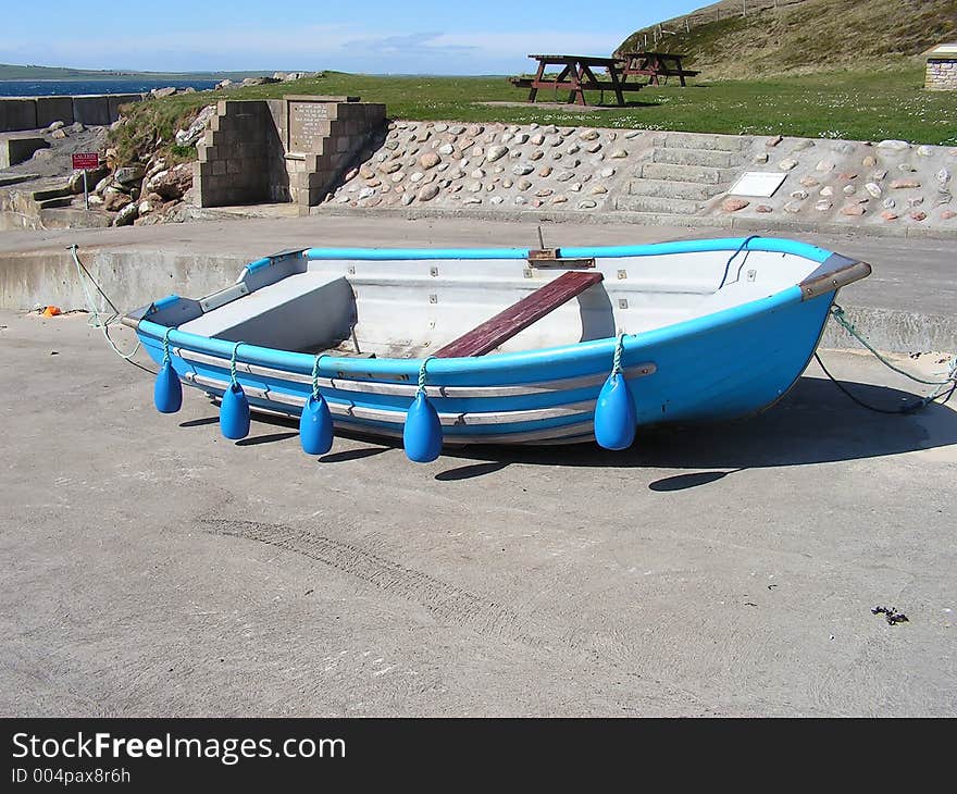 A rowing boat on the slipway of a remote pier waiting for the summer fun to begin.