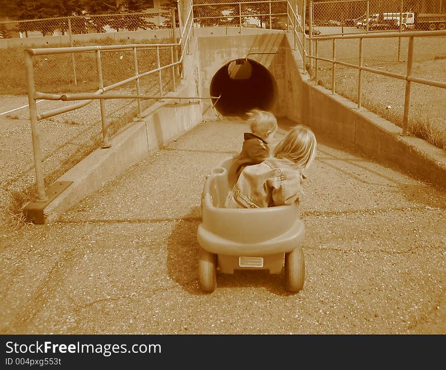 Two children looking at a tunnel under the highway, ready to go through for the first time. Two children looking at a tunnel under the highway, ready to go through for the first time.