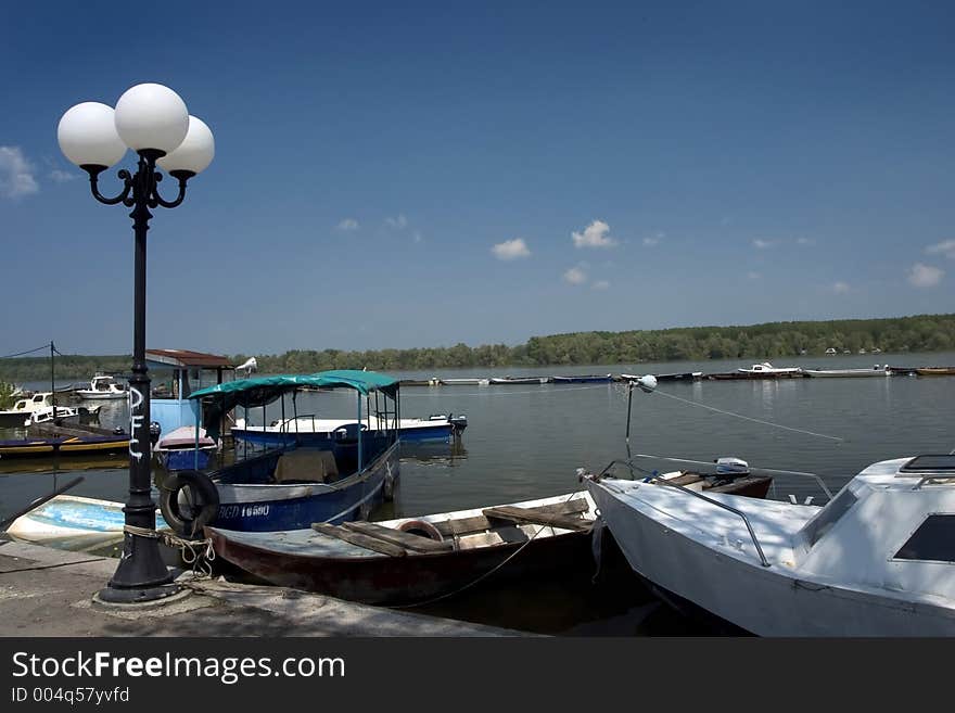 Old lamp in the riverside with sky on background