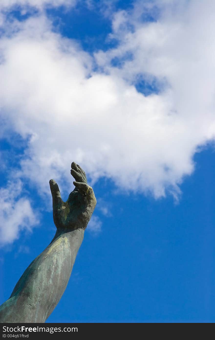 Stone hand on a background of the blue sky. Stone hand on a background of the blue sky