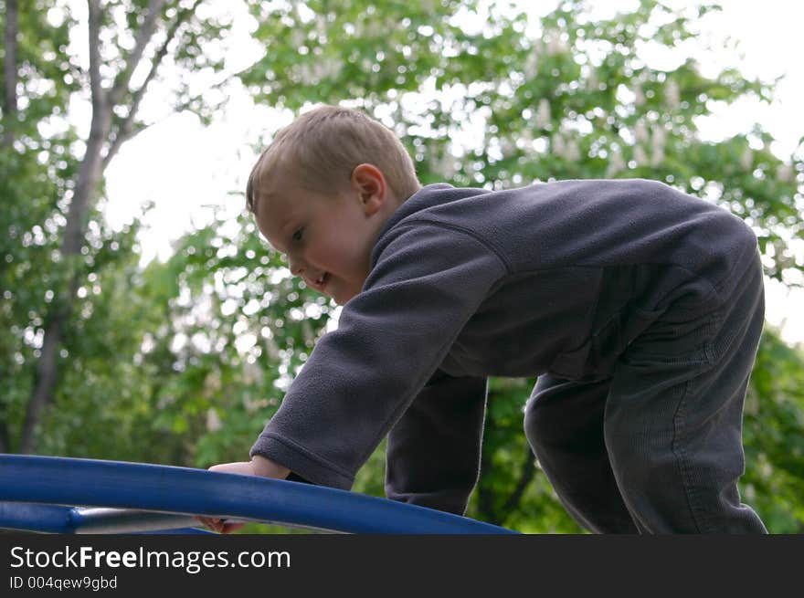 Child climbing on the park toys