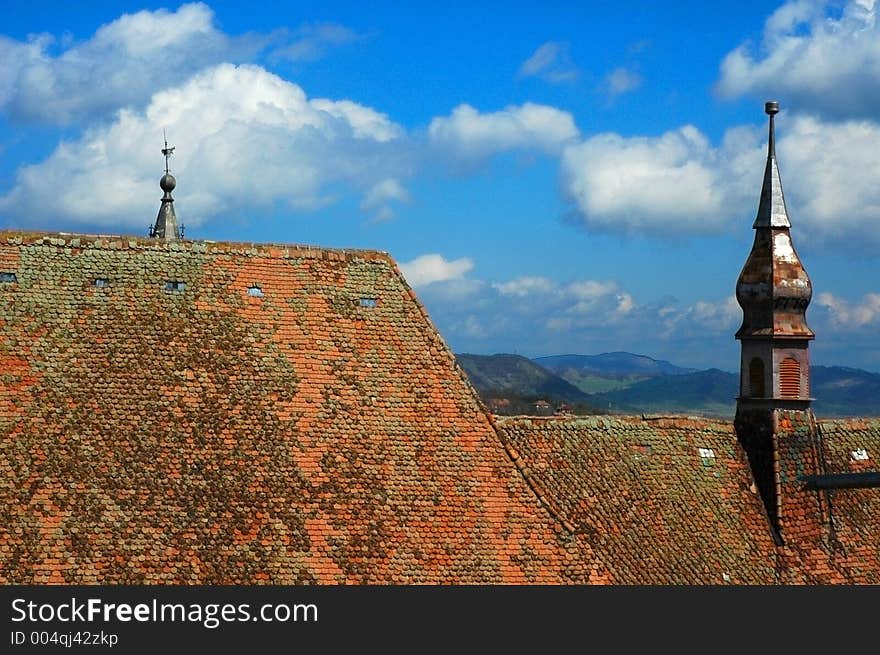 Roof of a gothic cathedral, against a blue cloudy sky. Roof of a gothic cathedral, against a blue cloudy sky.