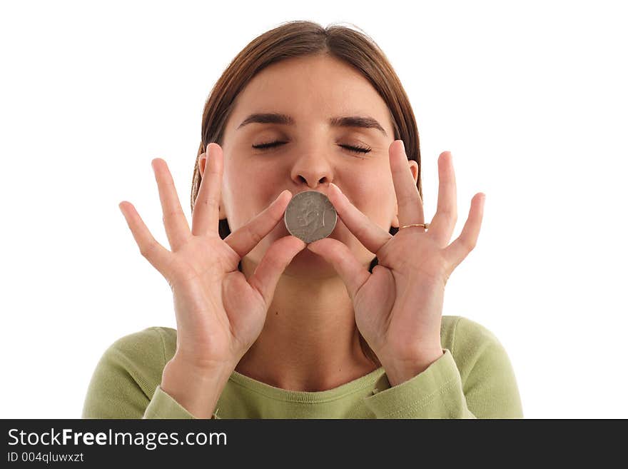 Stock photo of a young woman kissing silver dollar. Stock photo of a young woman kissing silver dollar