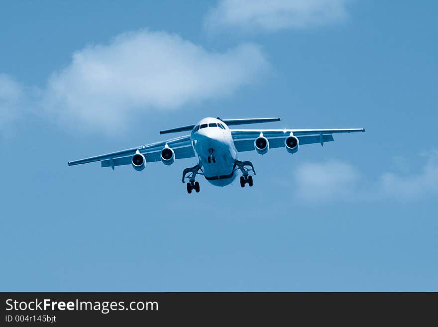 Small airliner coming into land. Blue toned image. Small airliner coming into land. Blue toned image