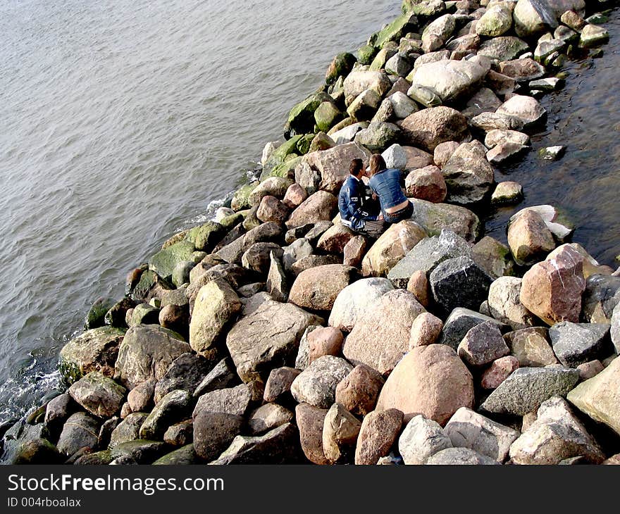 Sea,stones and couple. Sea,stones and couple