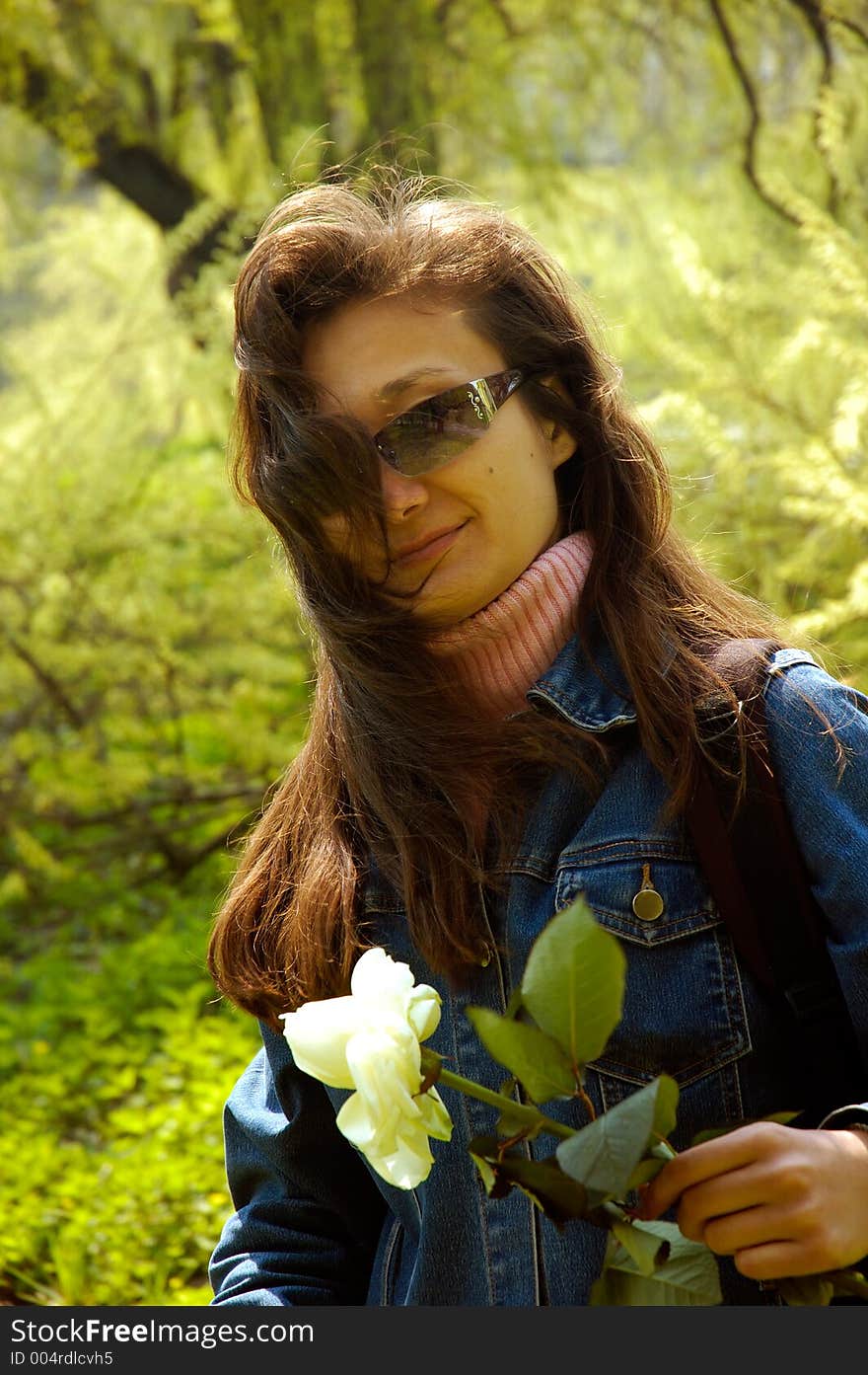 Young beautiful happy woman hiking in forest with a white rose. Young beautiful happy woman hiking in forest with a white rose