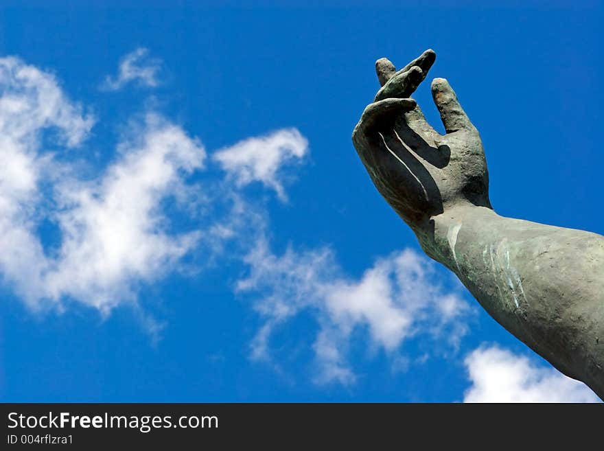 Stone hand on a background of the blue sky. Stone hand on a background of the blue sky