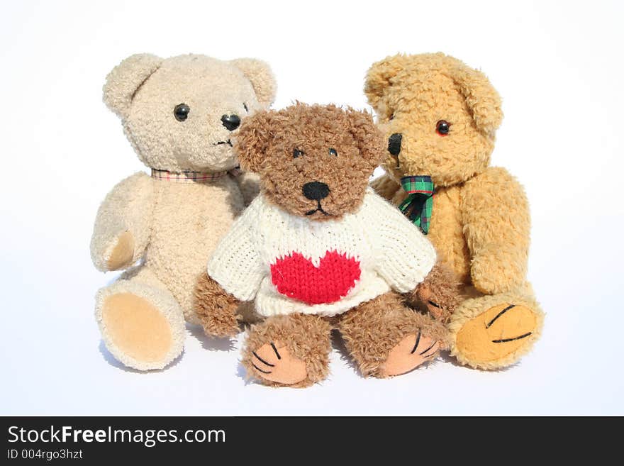 Group of teddy bears sitting on white background