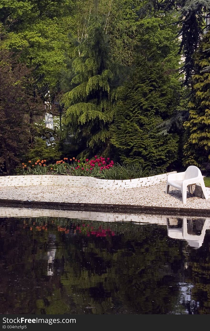 Backyard along a river with a tulip garden and bench. Backyard along a river with a tulip garden and bench