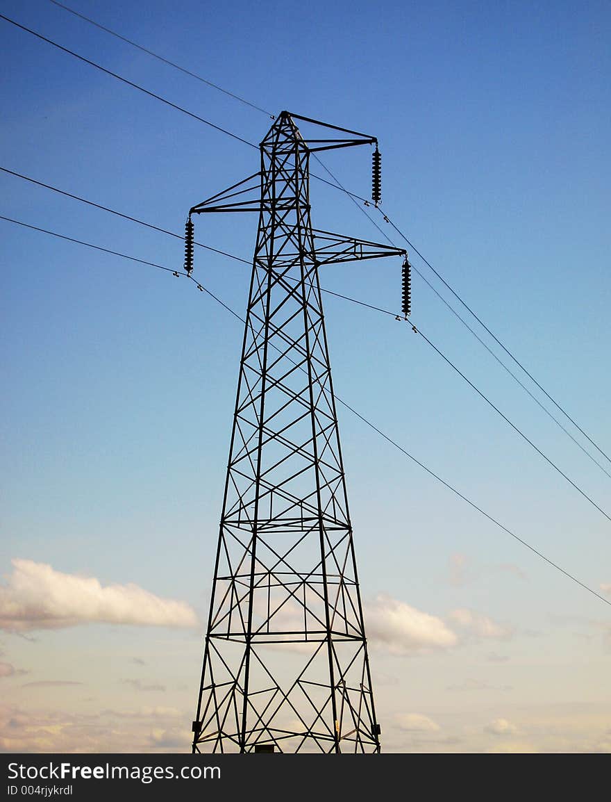 An electricity pylon carries power across the land. An electricity pylon carries power across the land