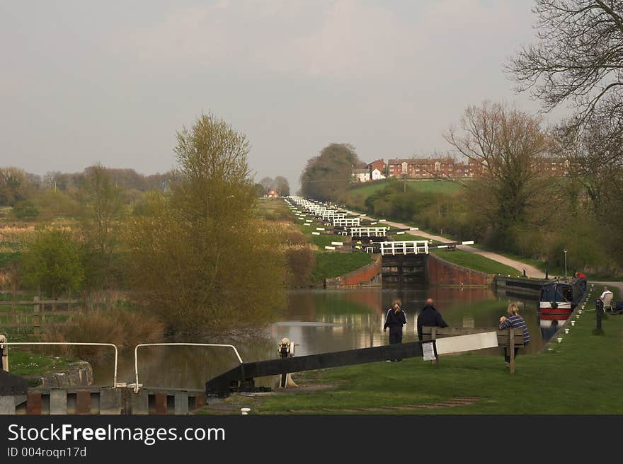 People relaxing beside canal