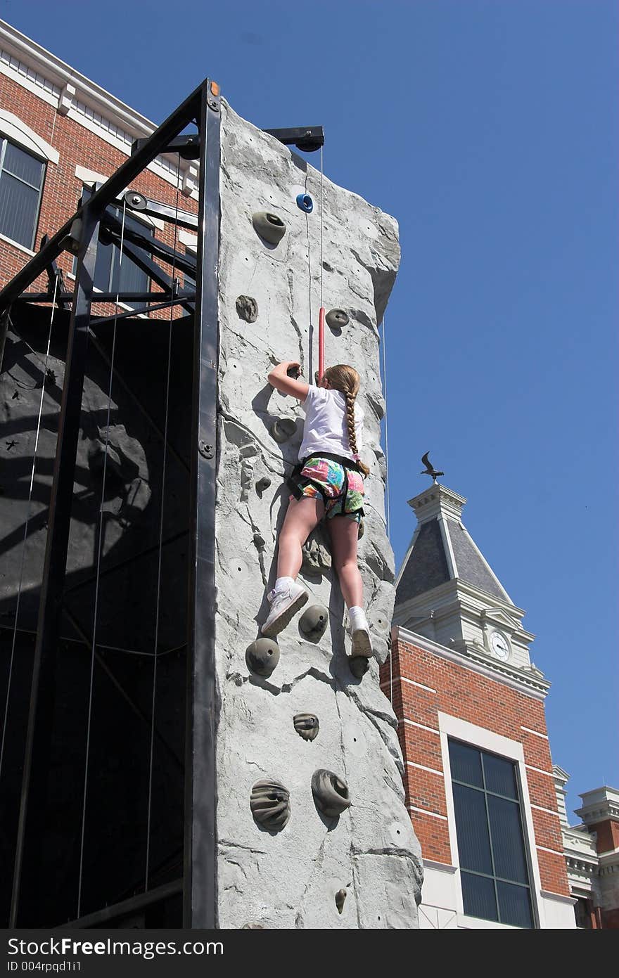 Child leaning how to rock climb. Child leaning how to rock climb