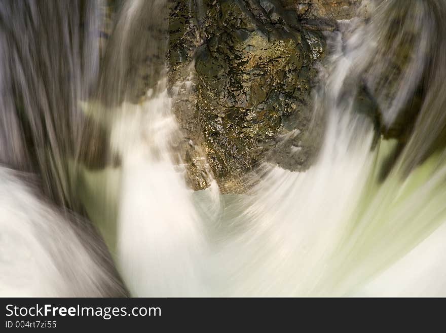 Water abstract with sharp rock and smooth flowing water