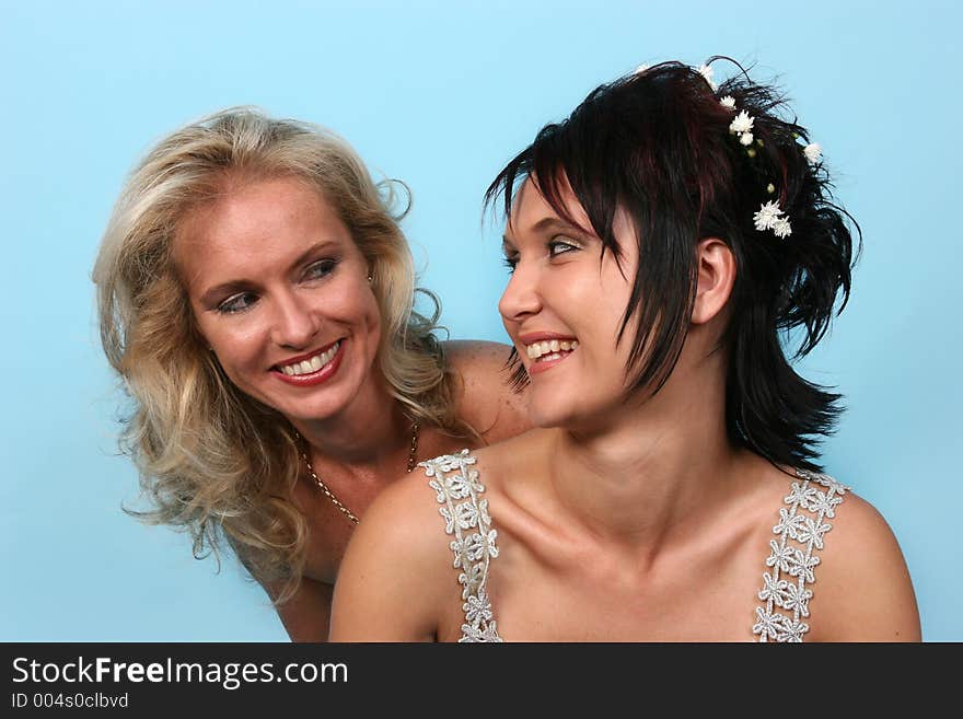 Two woman looking at each other, isolated on blue. Two woman looking at each other, isolated on blue